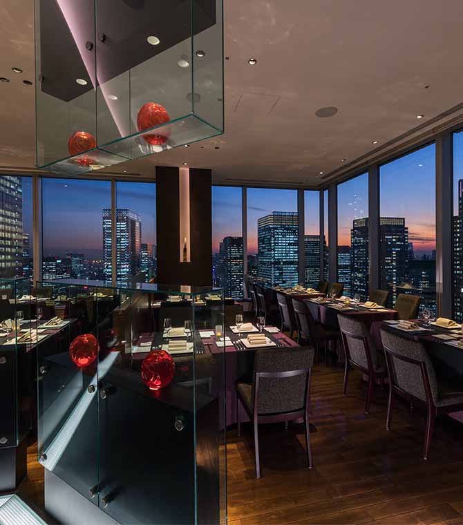 restaurant interior at sunset time over looking city view through window