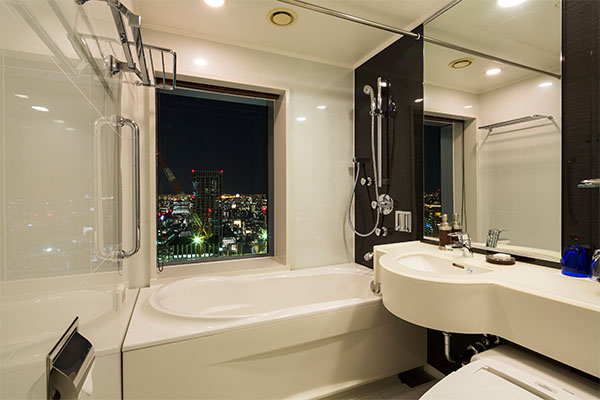 bathroom and bathroom sink with window and outside city view from the window