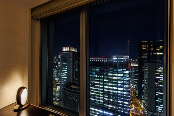 an outside view from the room looking down the city at night