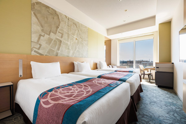 TRIPLE 25sqm room with 3 beds, desk, chair and stool at daytime
